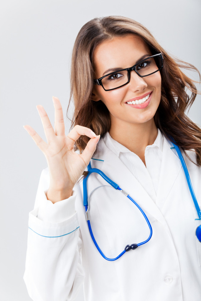 Female doctor with okay gesture, over grey